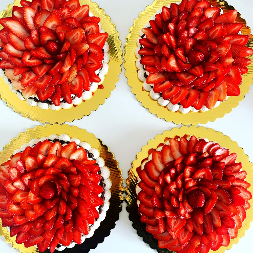 Close-up detail of a Cakish pavlova's strawberry floral pattern.
